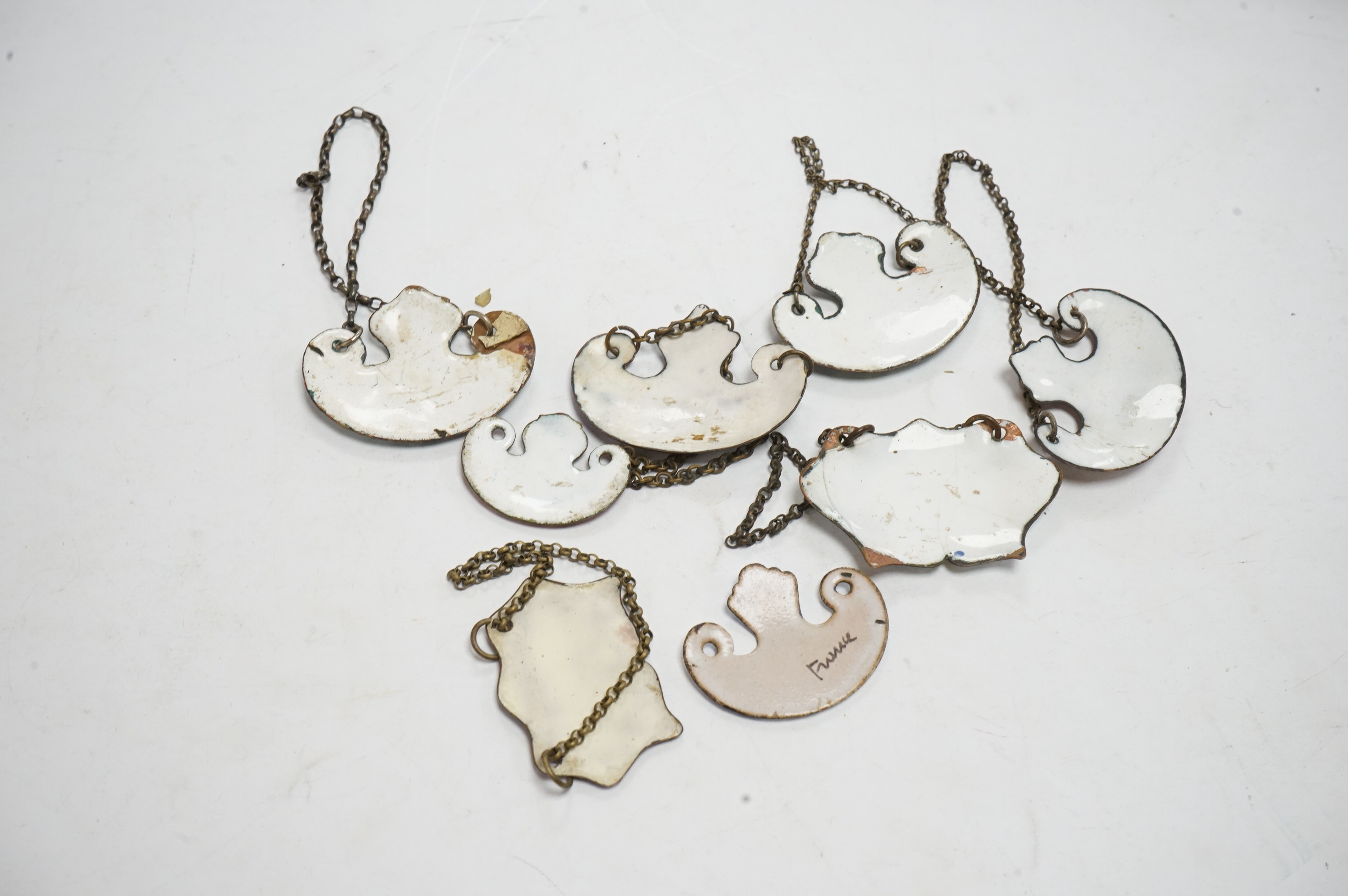 A collection of enamelled wine and spirit decanter labels. Condition - some damage to the enamel